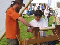Paul and Thomas using a pole lathe