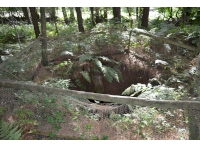 View of the the old well, fenced off as it still holds water